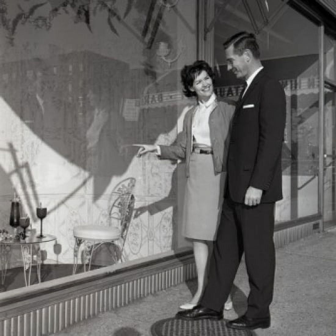 Mid adult couple watching window display Canvas Art - (24 x 36)