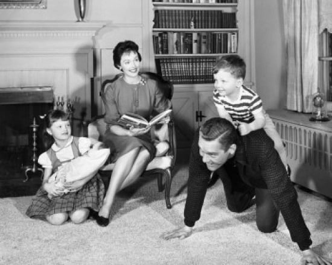 Mid adult couple with children near fireplace Canvas Art - (18 x 24)