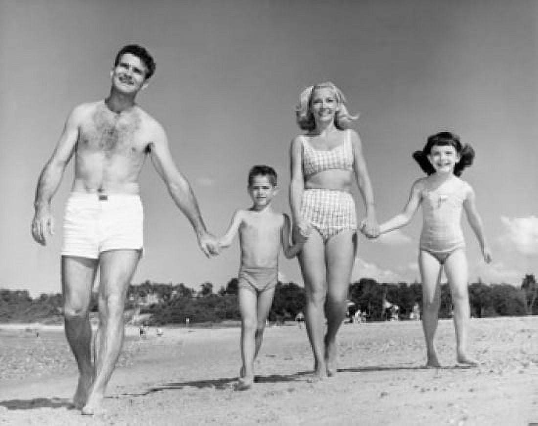 Mid adult couple with children walking on beach Canvas Art - (24 x 36)
