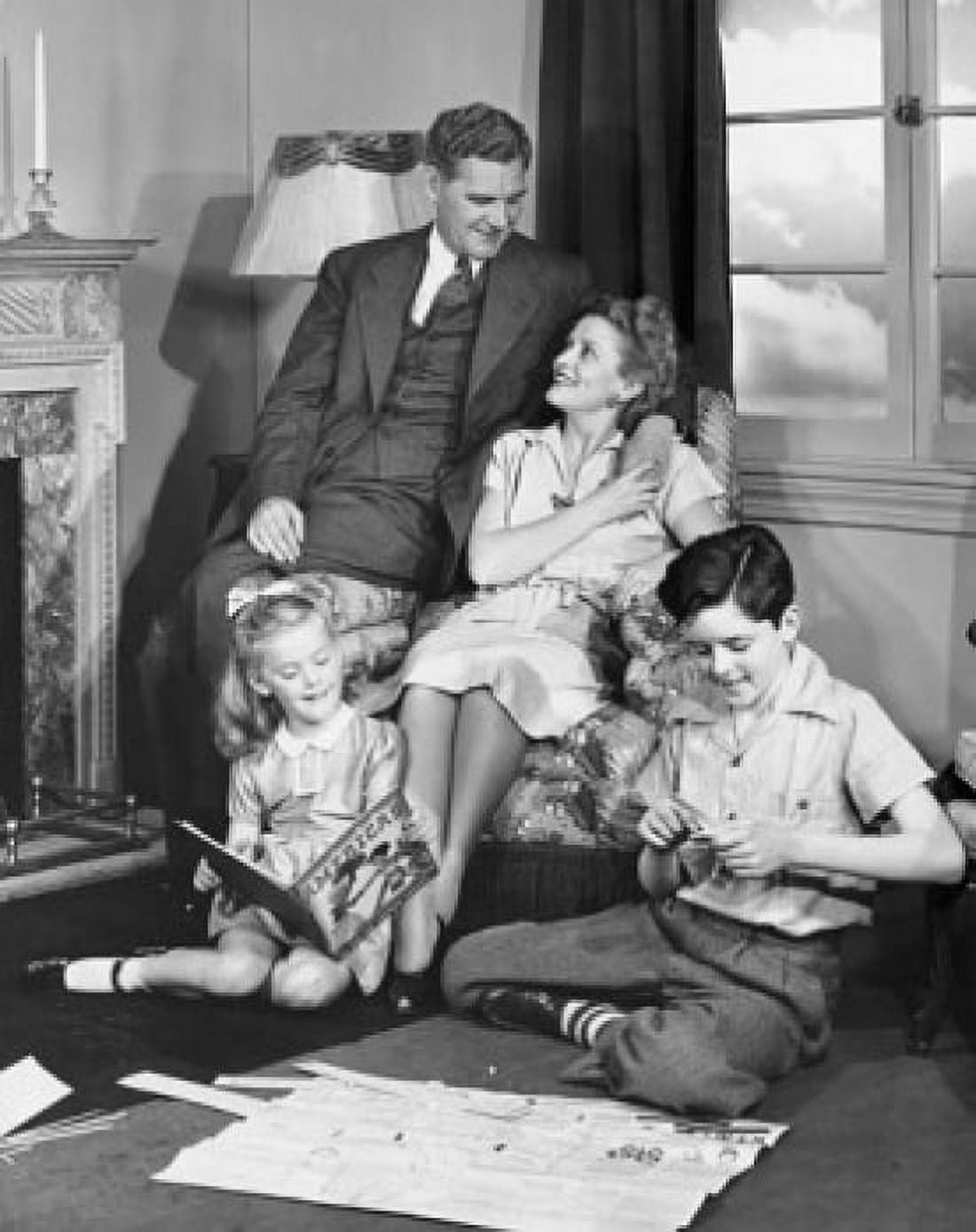 Mid adult couple with their two children in a living room Canvas Art - (18 x 24)