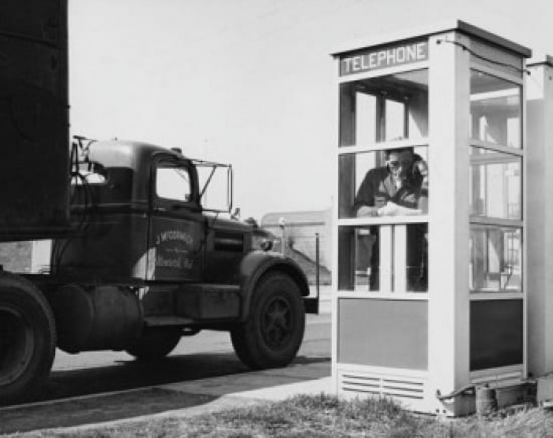 Mid adult man a talking on the phone in a telephone booth Canvas Art - (18 x 24)