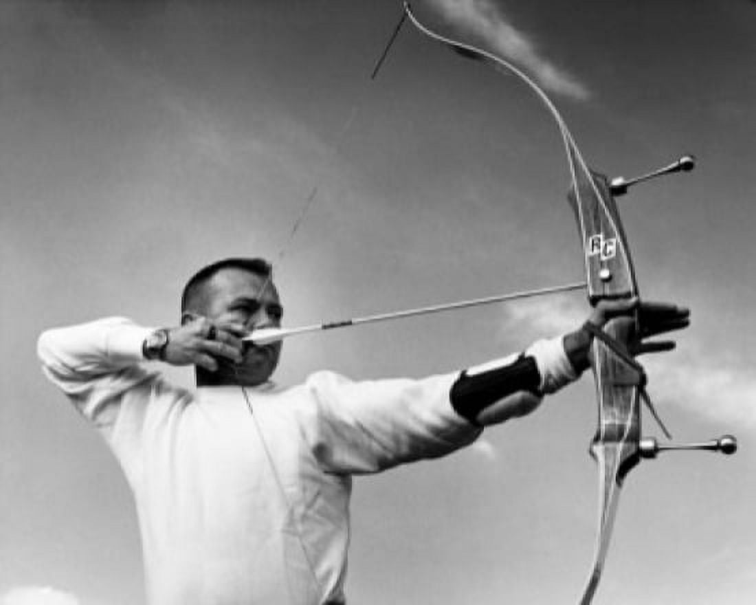 Mid adult man aiming with a bow and arrow Canvas Art - (24 x 36)