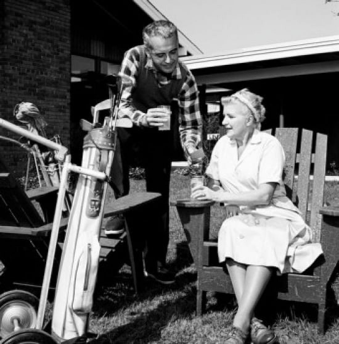 Mid adult man and mother having break from playing golf Canvas Art - (24 x 36)