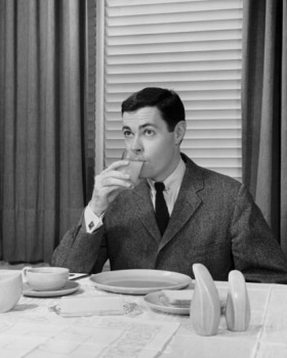 Mid adult man drinking juice Canvas Art - (18 x 24)