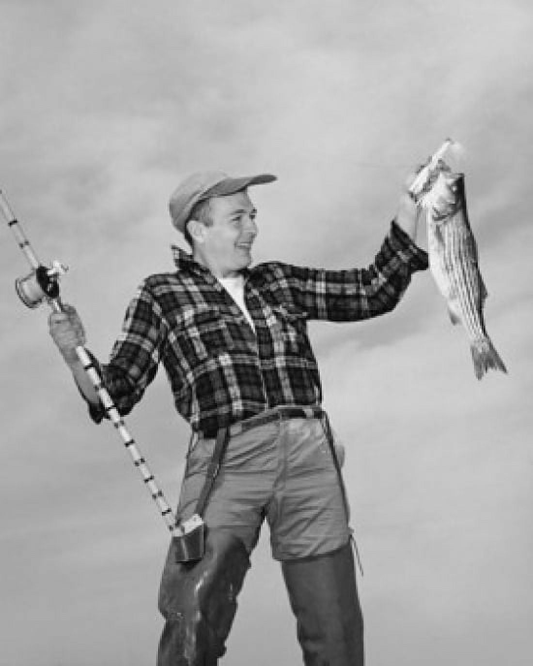Mid adult man holding dead fish and fishing pole Canvas Art - (18 x 24)