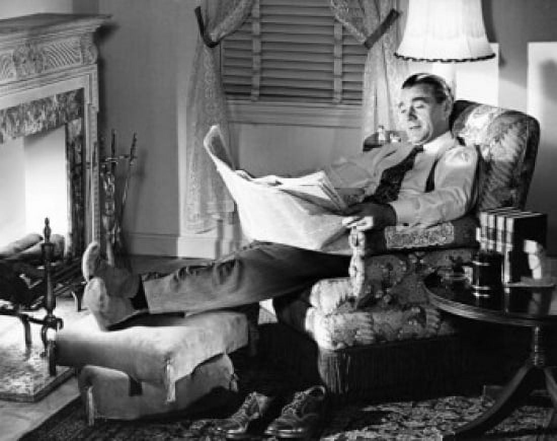 Mid adult man reading newspaper in armchair Canvas Art - (18 x 24)