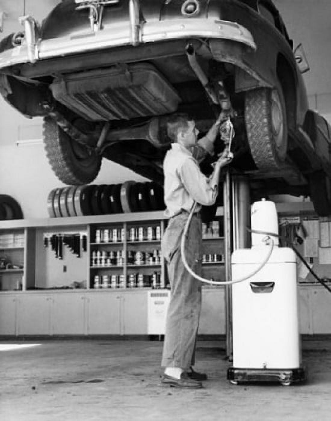 Mid adult man repairing a car in an auto repair shop Canvas Art - (18 x 24)
