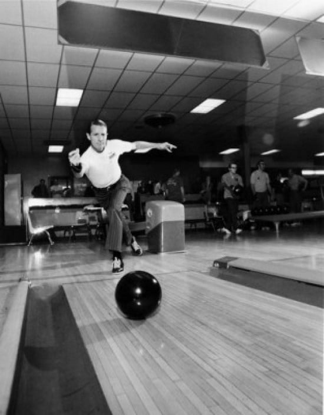 Mid adult man rolling a bowling ball in a bowling alley Canvas Art - (18 x 24)
