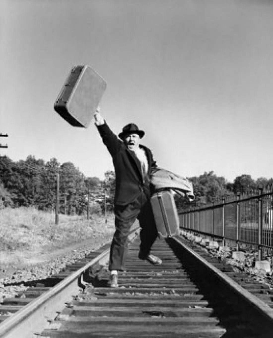 Mid adult man running with luggage on a railroad track Canvas Art - (18 x 24)