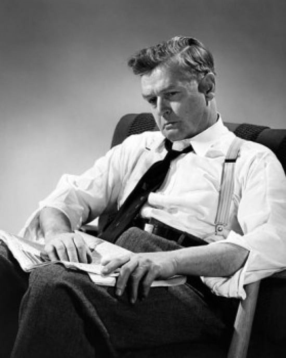 Mid adult man sitting in an armchair and thinking Canvas Art - (18 x 24)