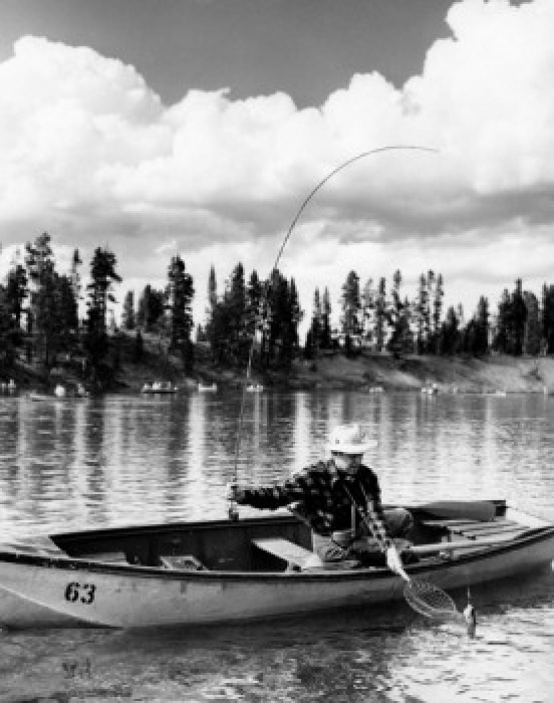 Mid adult man sitting on a rowboat and fishing in a lake Canvas Art - (18 x 24)