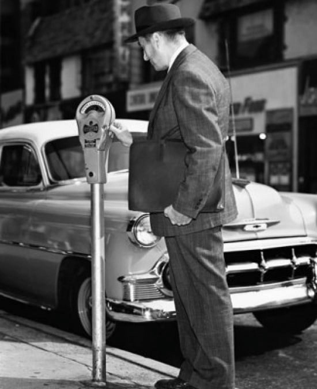 Mid adult man using a parking meter Canvas Art - (18 x 24)