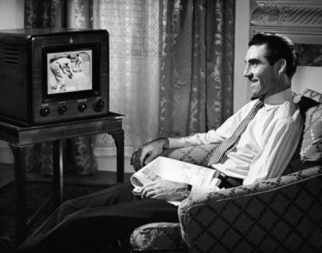 Mid adult man watching television Canvas Art - (18 x 24)