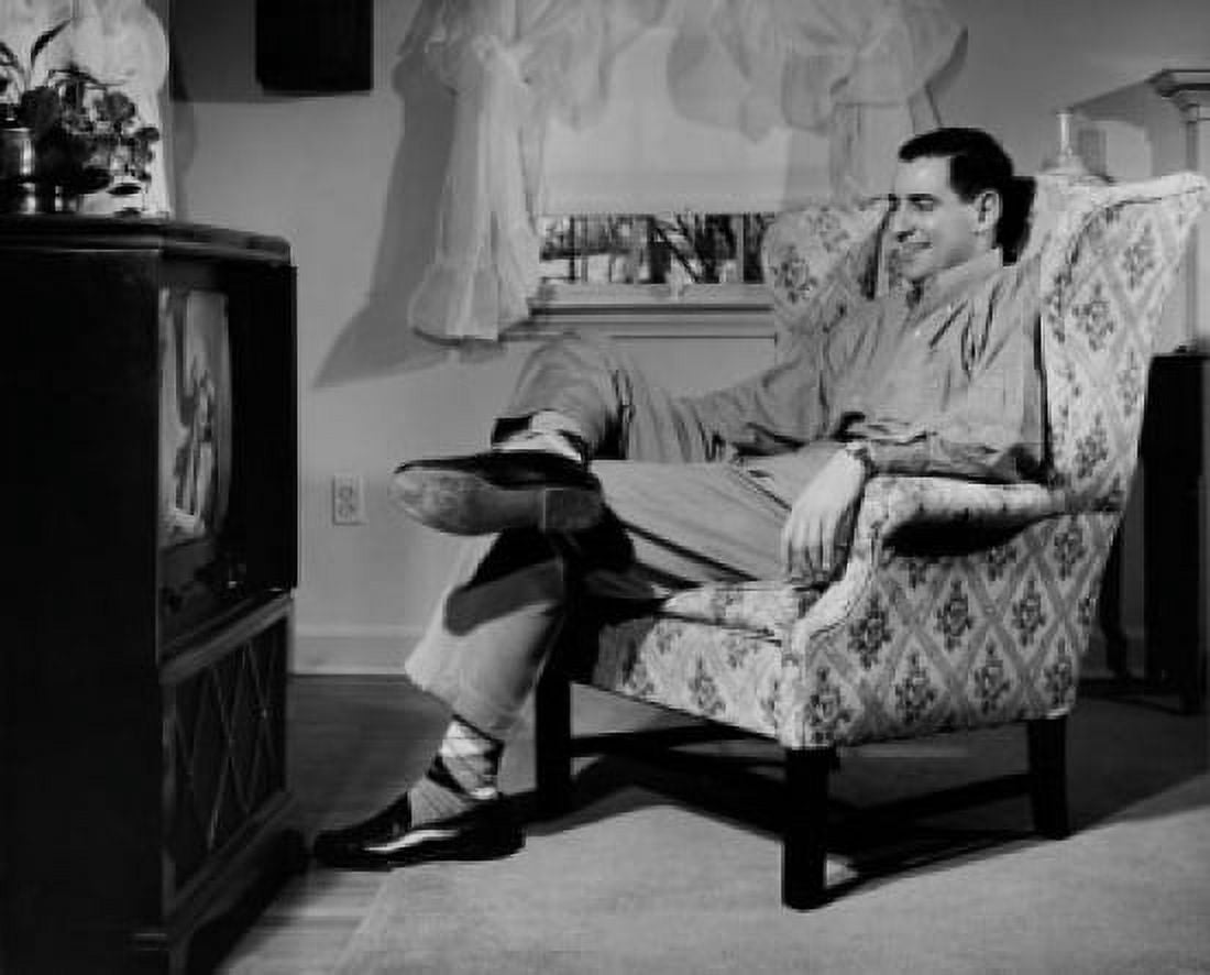 Mid adult man watching television Canvas Art - (18 x 24)
