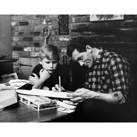 Mid adult man with his son building a model Canvas Art - (18 x 24)