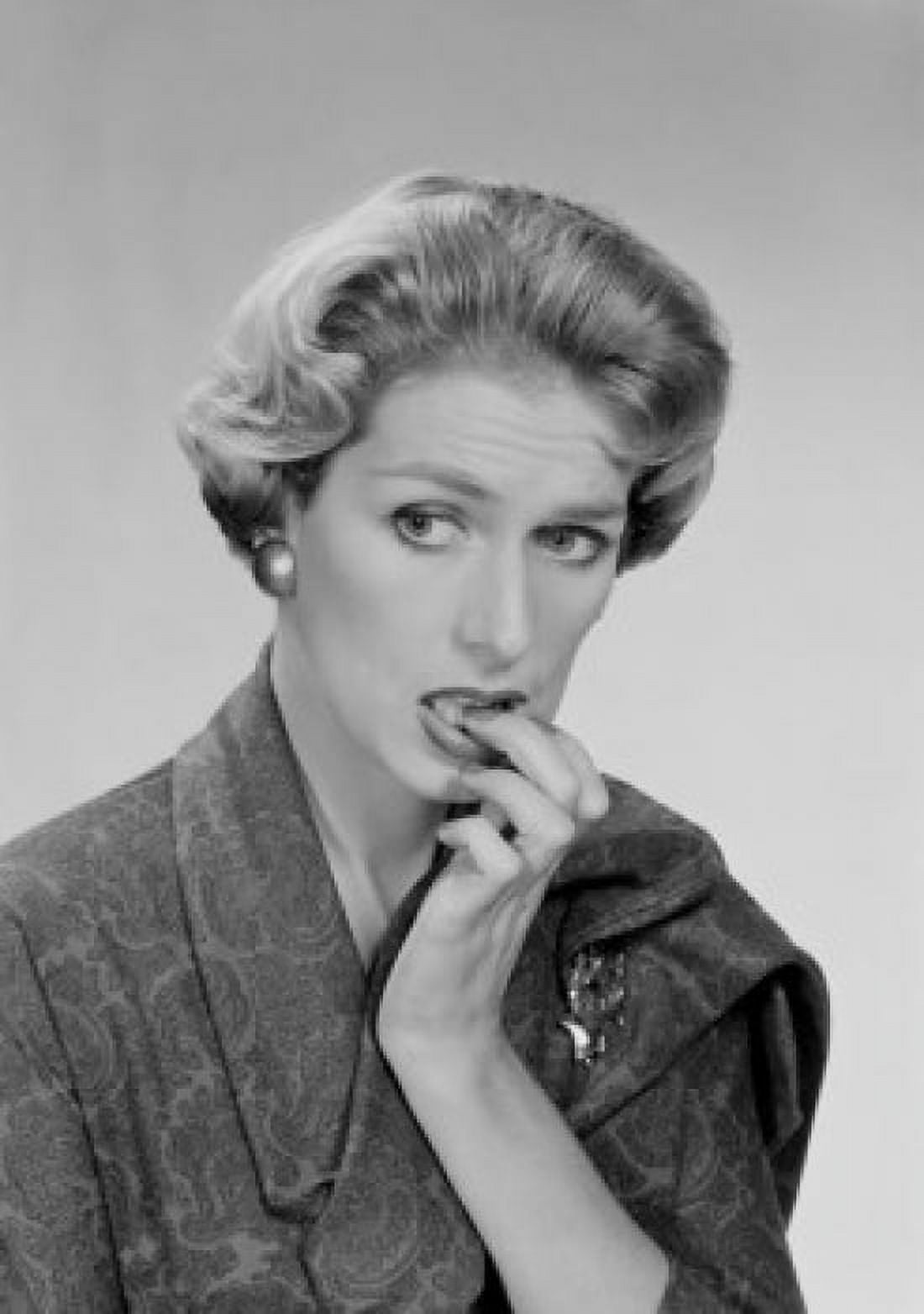 Mid adult woman biting her nails and looking away studio shot Canvas Art - (18 x 24)