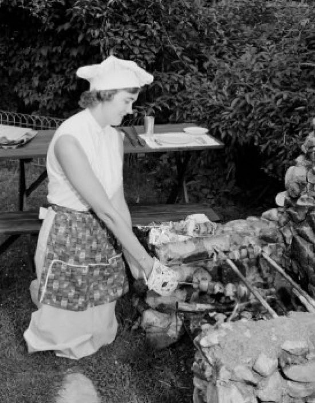 Mid-adult woman cooking on outdoor grill Canvas Art - (24 x 36)