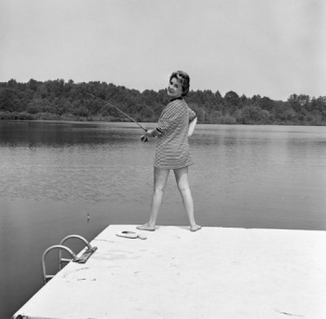 Mid adult woman fishing from jetty Canvas Art - (18 x 24)