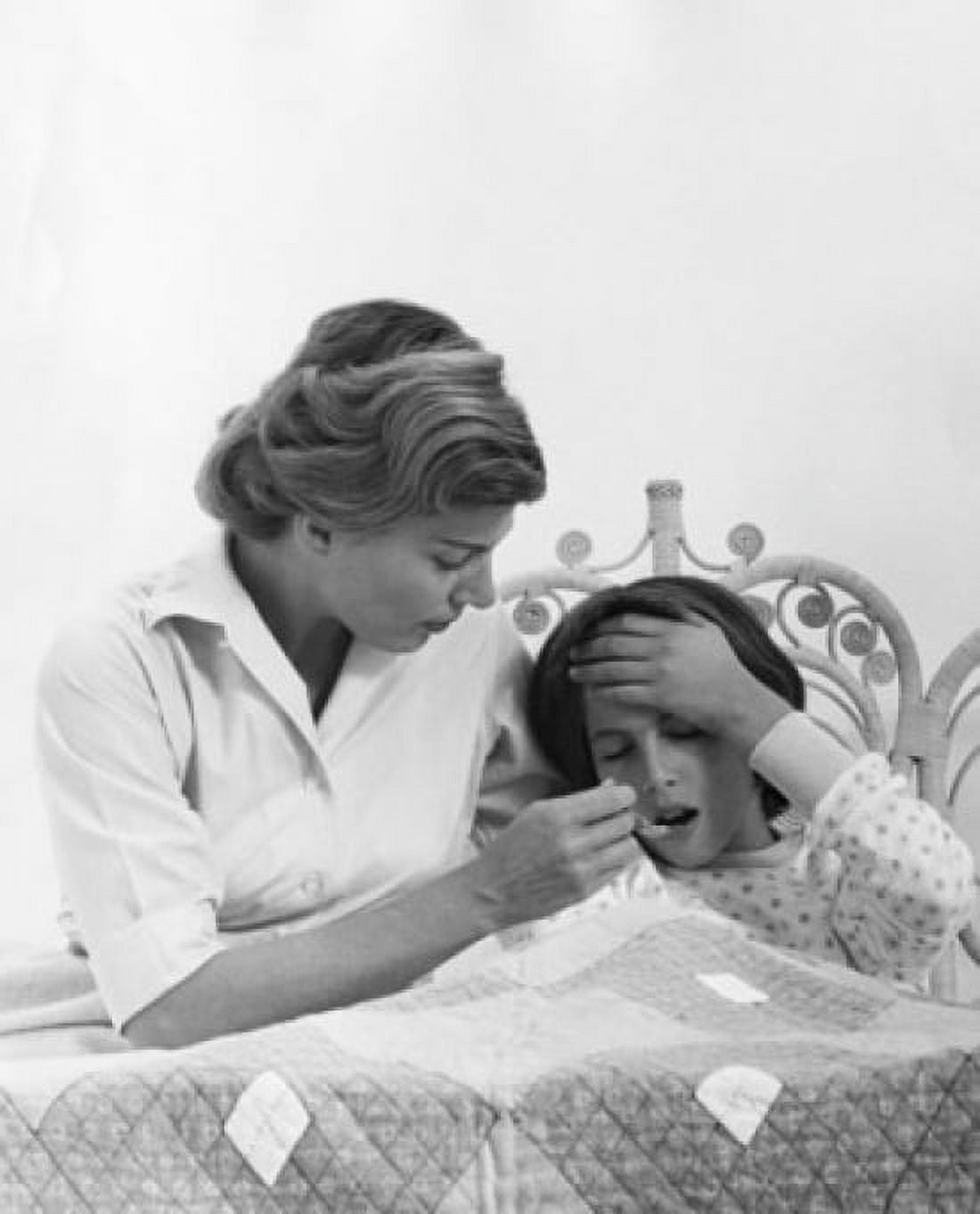 Mid adult woman giving medicine to her daughter Canvas Art - (18 x 24)