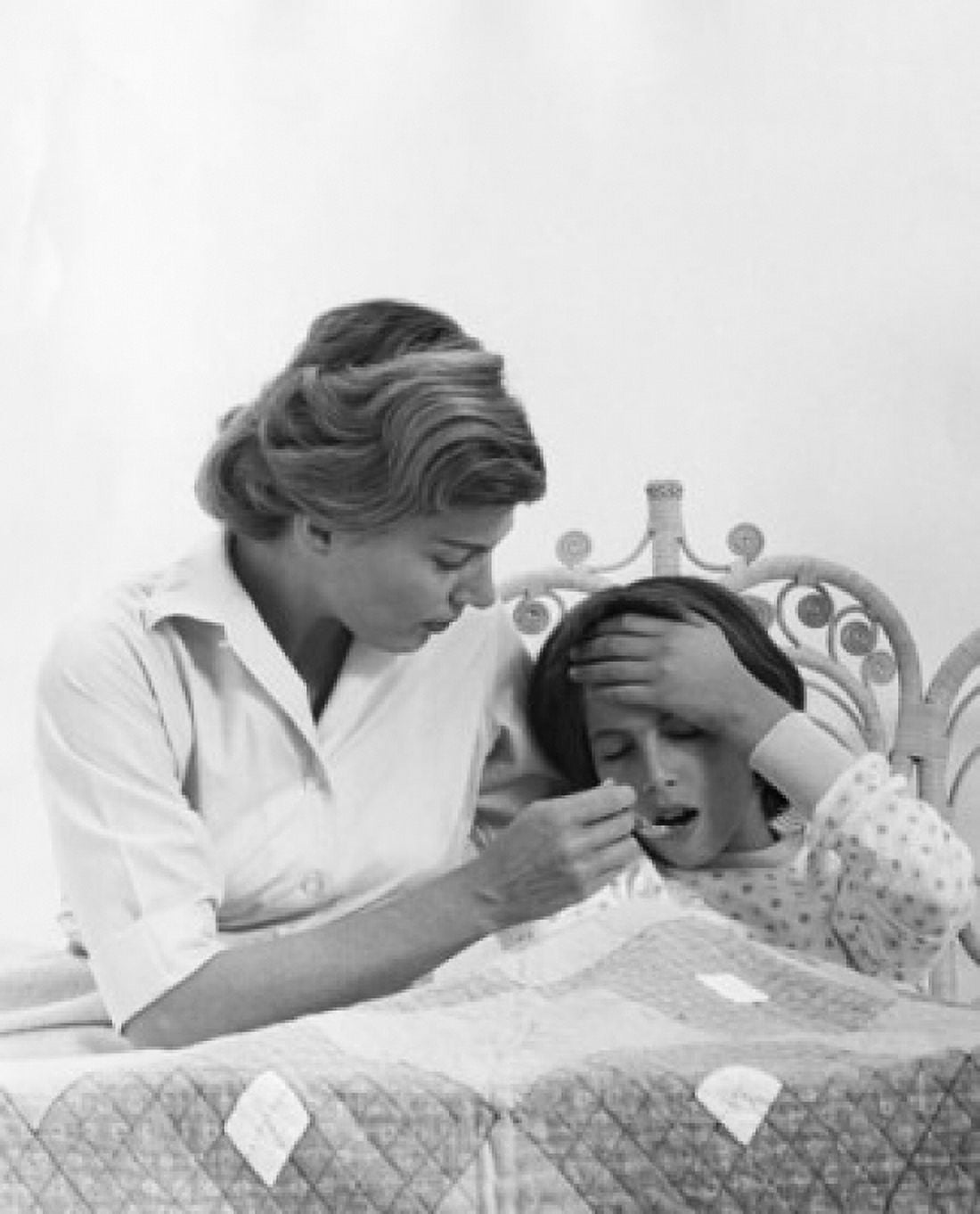 Mid adult woman giving medicine to her daughter Canvas Art - (24 x 36)