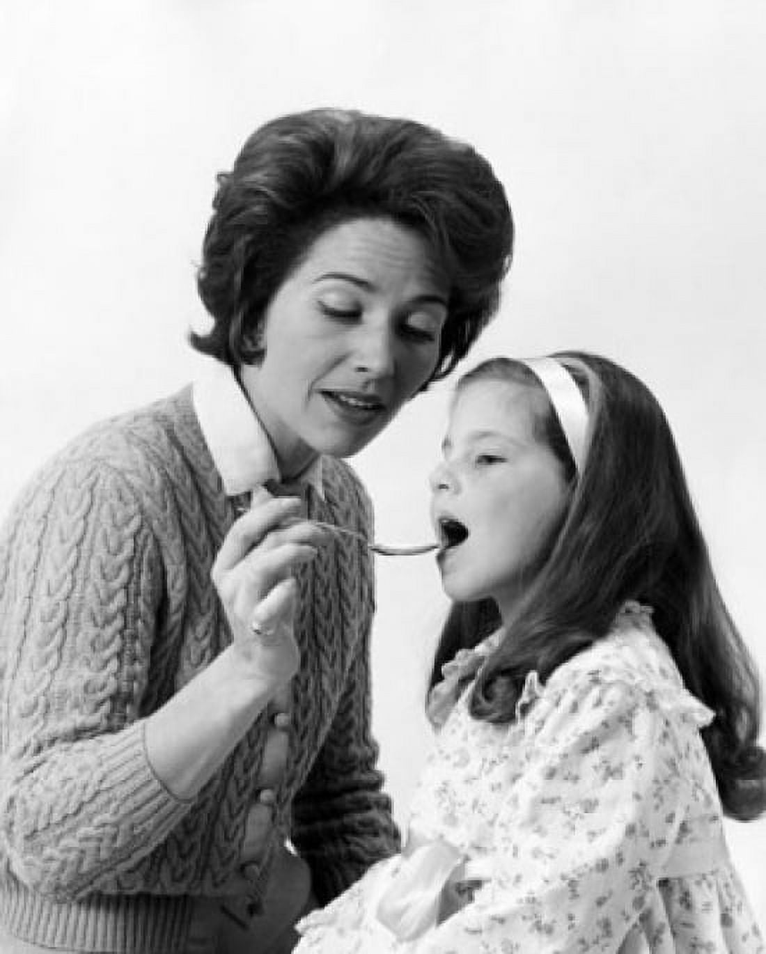 Mid adult woman giving medicine to her daughter Canvas Art - (24 x 36)