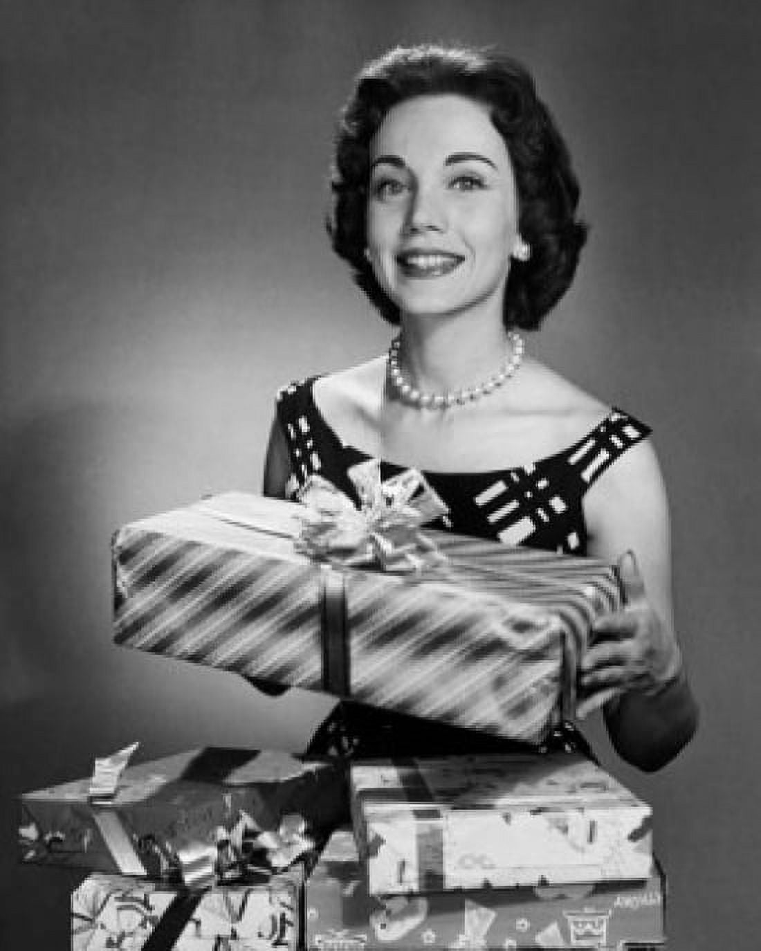 Mid adult woman holding a gift Canvas Art - (24 x 36)