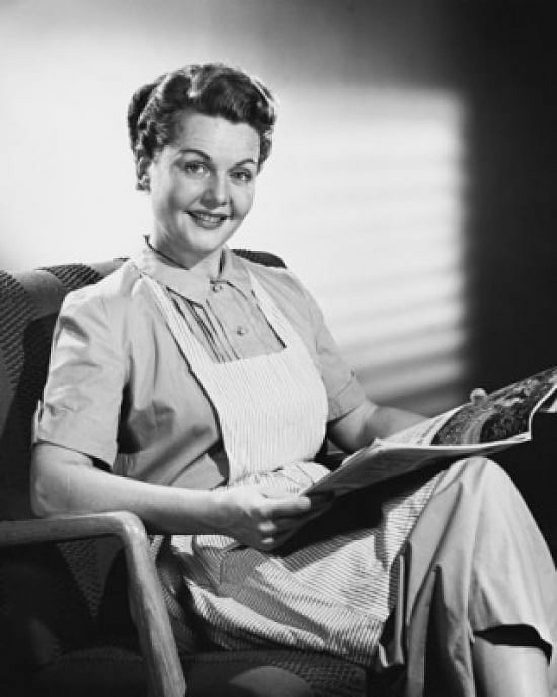 Mid adult woman holding a magazine and smiling Canvas Art - (24 x 36)