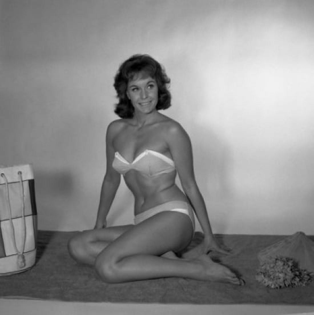 Mid adult woman in bikini sitting on towel Canvas Art - (18 x 24)