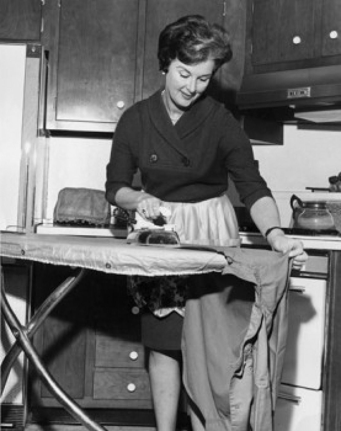 Mid adult woman ironing clothes Canvas Art - (18 x 24)