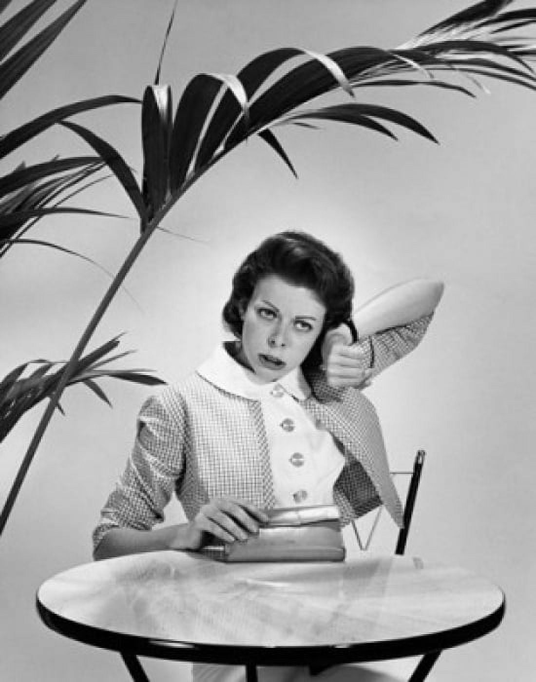 Mid adult woman listening to her wristwatch and looking impatient Canvas Art - (24 x 36)