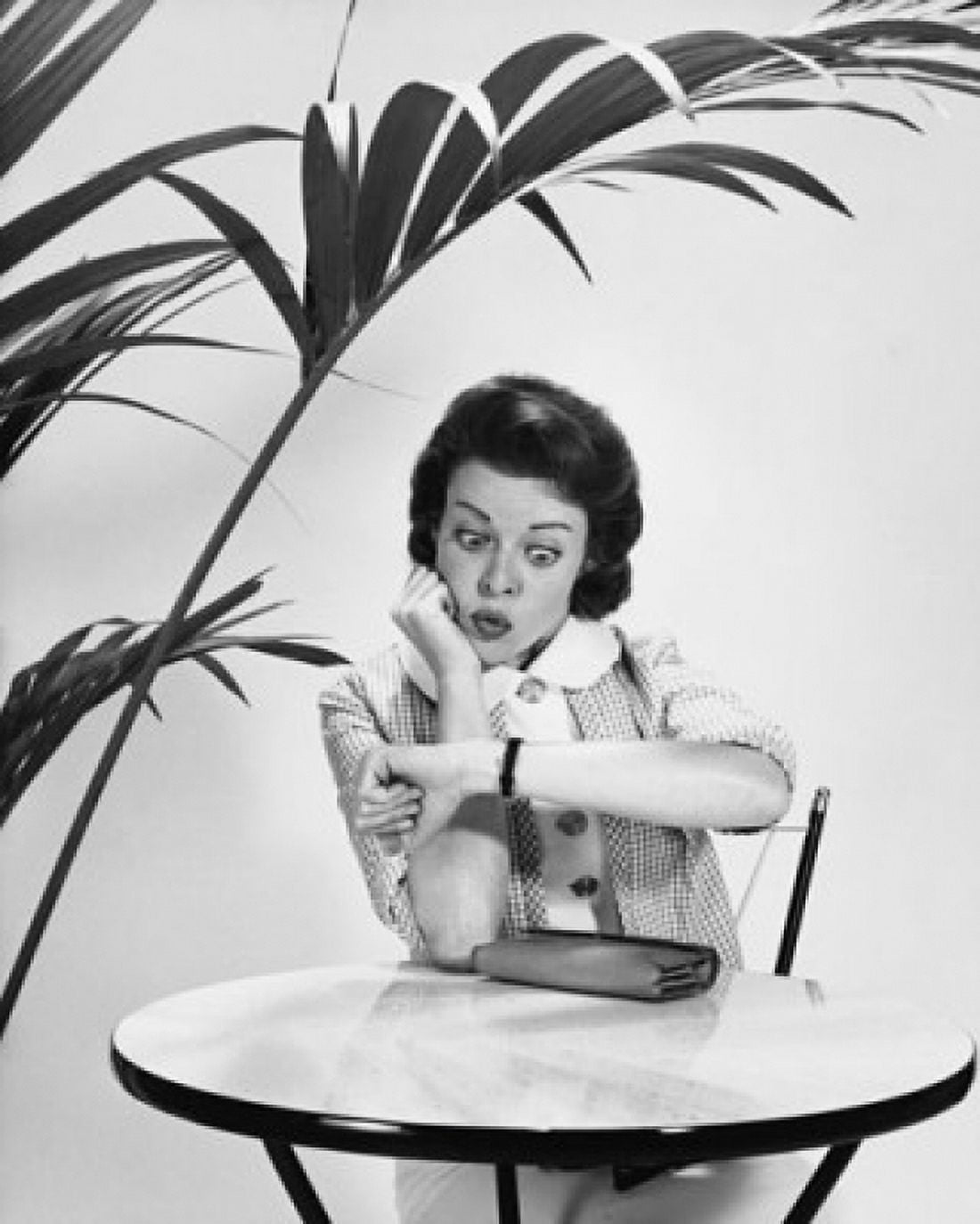 Mid adult woman looking at her wristwatch Canvas Art - (18 x 24)