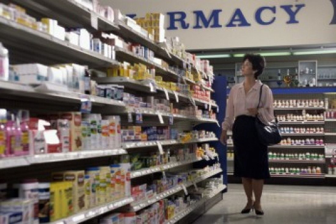 Mid adult woman looking at medicines in a pharmacy Canvas Art - (18 x 24)