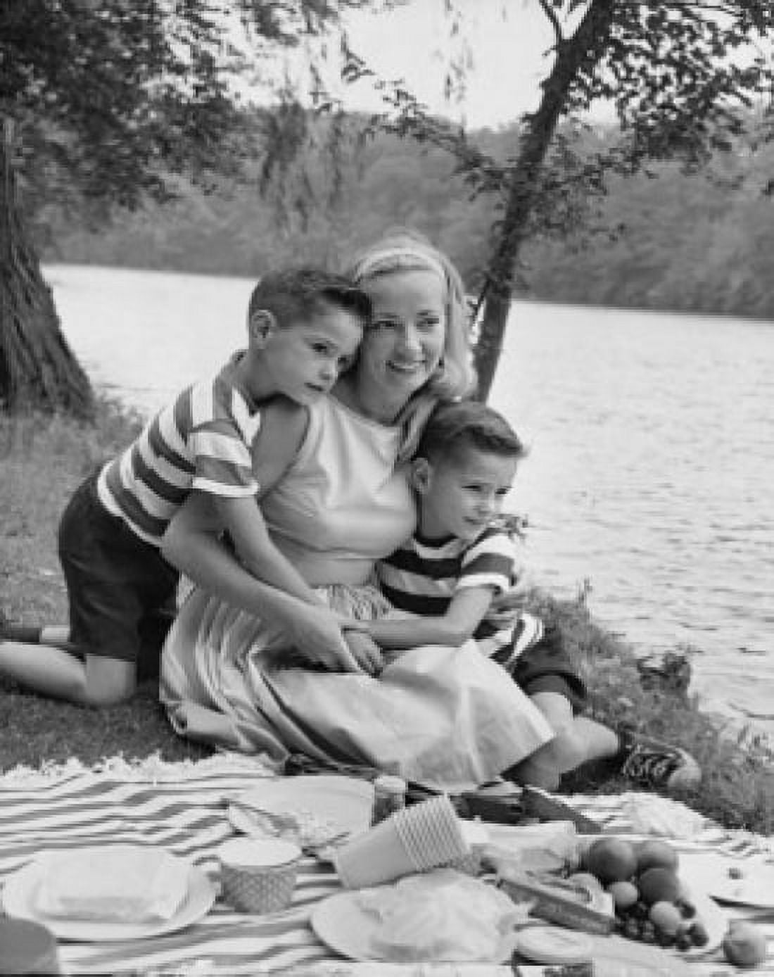Mid adult woman picnicking with her two sons at a riverbank Canvas Art - (18 x 24)