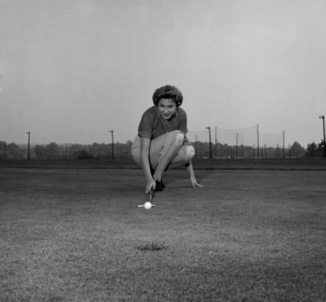 Mid adult woman playing golf on a golf course Canvas Art - (24 x 36)