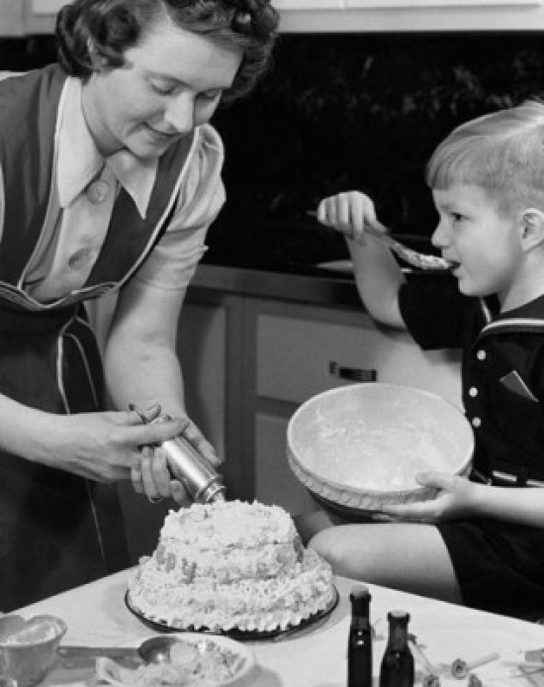 Mid adult woman preparing a cake with her son sitting beside her Canvas Art - (18 x 24)