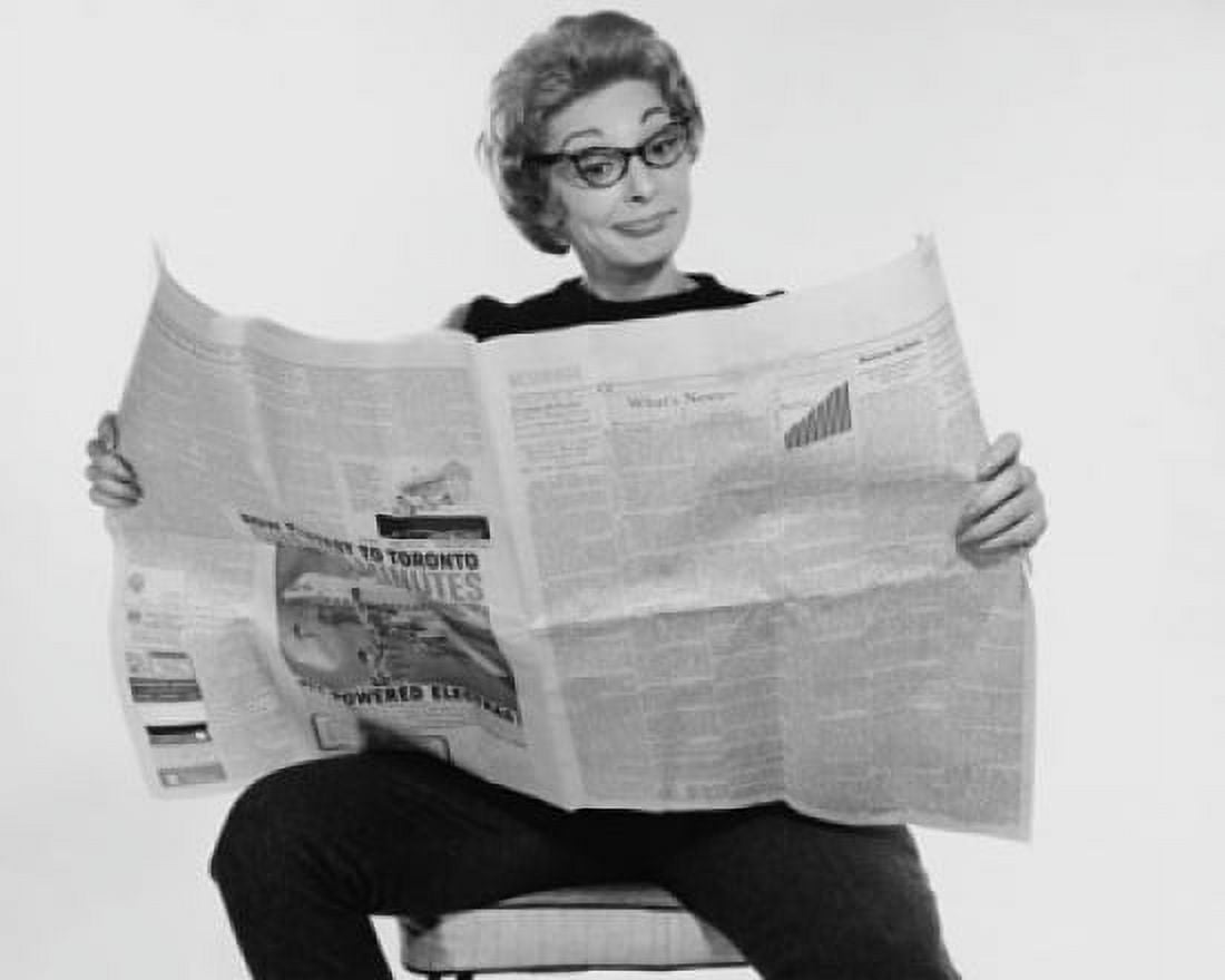 Mid adult woman reading a financial newspaper and making a face Canvas Art - (24 x 36)