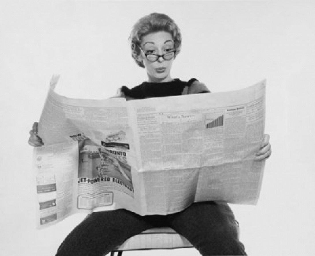 Mid adult woman reading a financial newspaper and making a face Canvas Art - (24 x 36)
