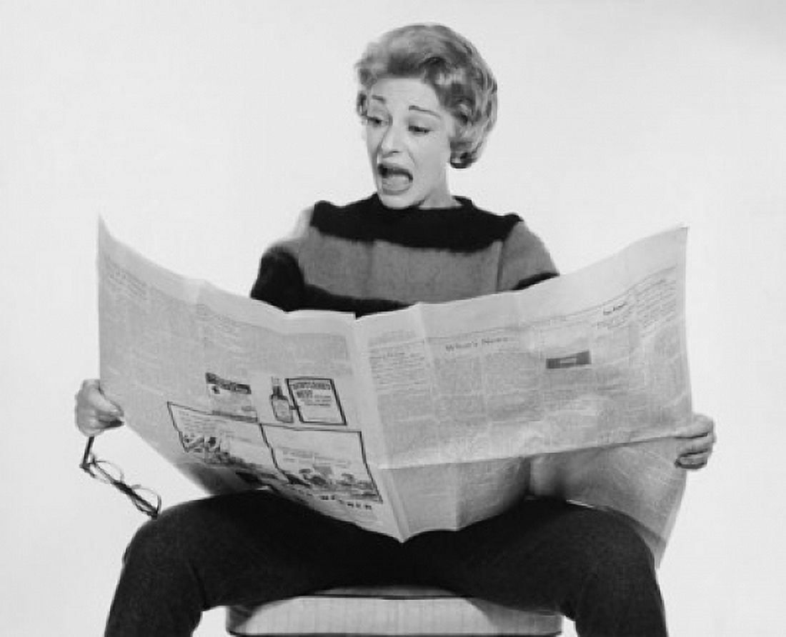 Mid adult woman reading a newspaper and looking surprised Canvas Art - (24 x 36)