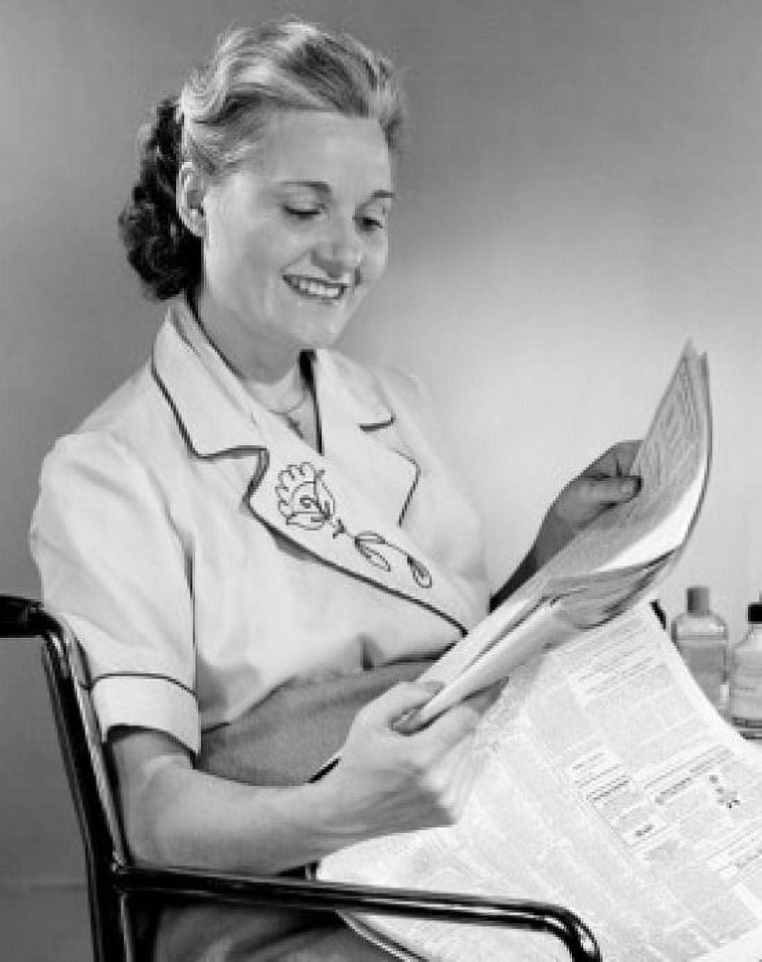 Mid adult woman reading newspaper Canvas Art - (24 x 36)