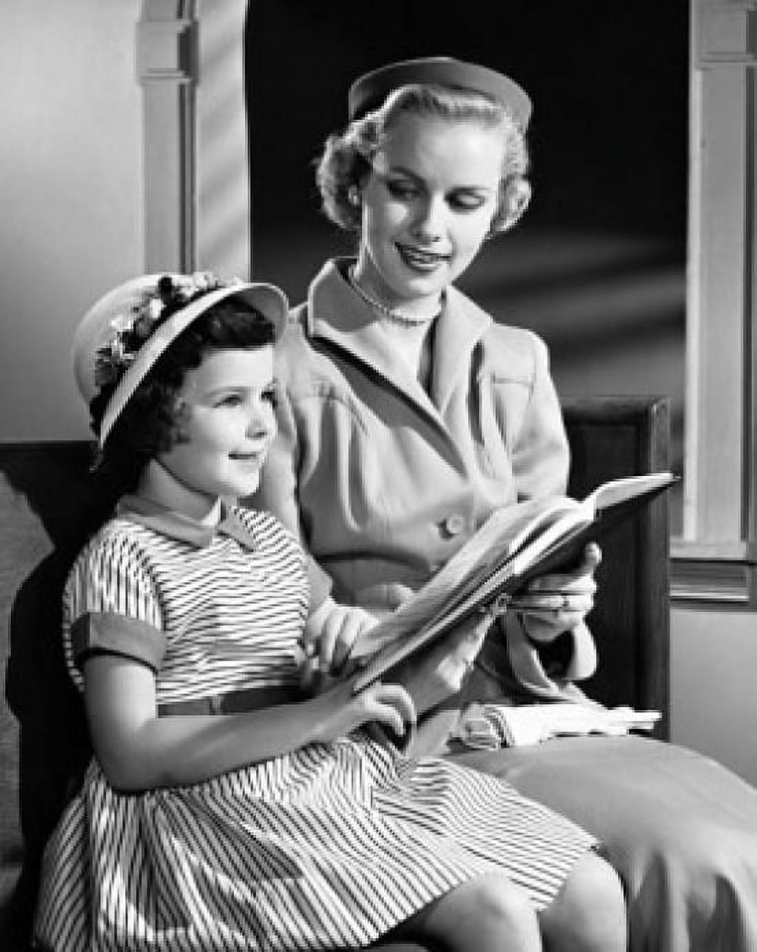 Mid adult woman sitting with her daughter and holding a Bible Canvas Art - (18 x 24)