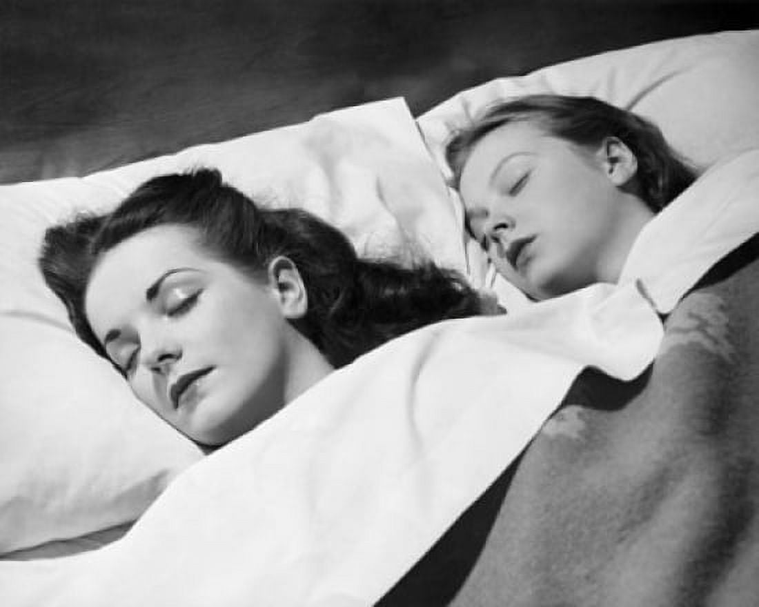 Mid adult woman sleeping with her daughter Canvas Art - (24 x 36)