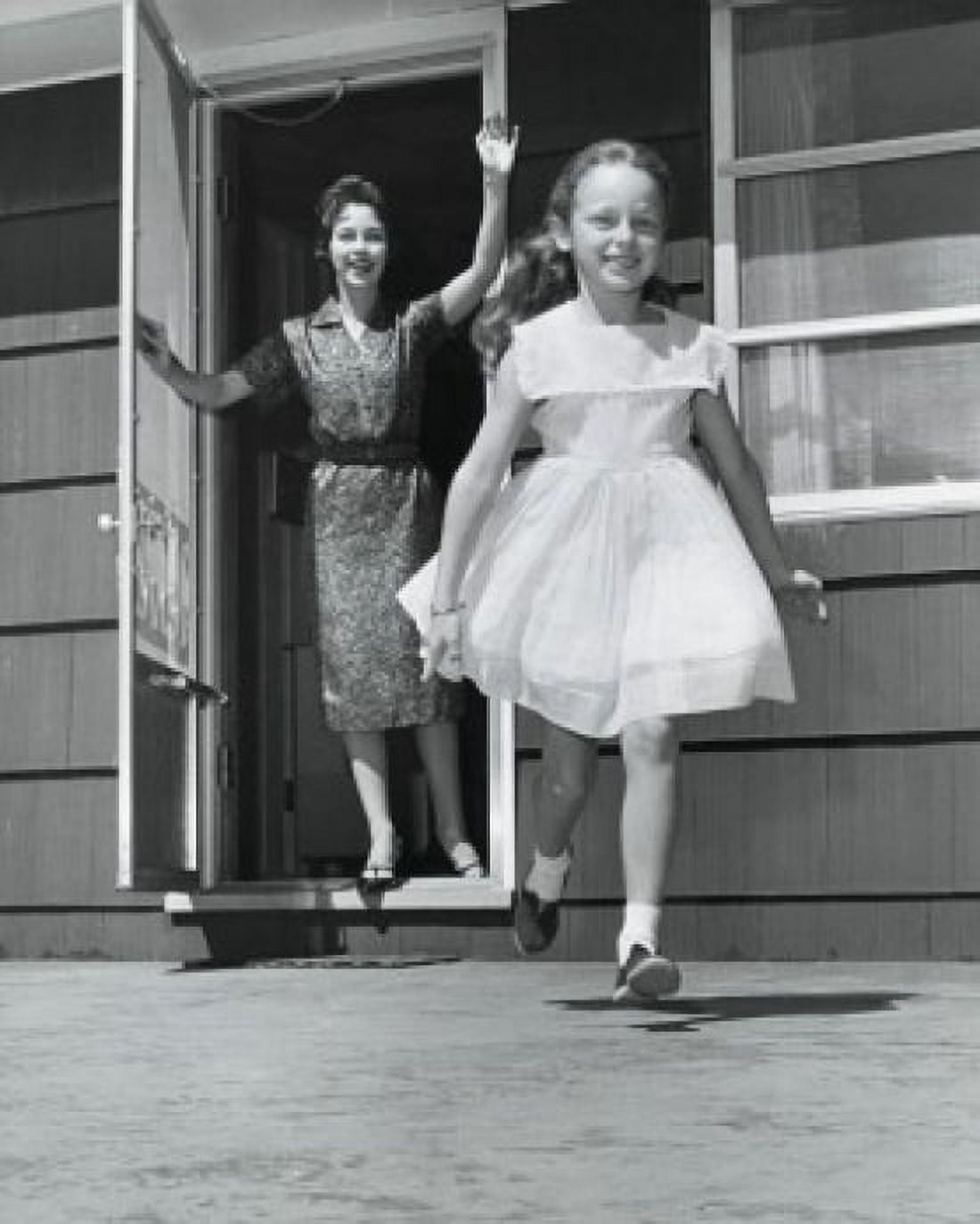 Mid adult woman standing in the doorway and waving to her daughter Canvas Art - (18 x 24)