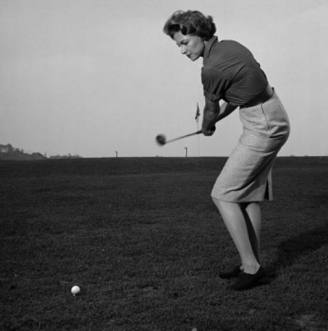 Mid adult woman swinging a golf club on a golf course Canvas Art - (18 x 24)