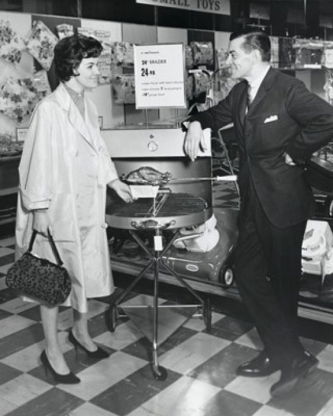 Mid adult woman talking to mature man in store Canvas Art - (24 x 36)