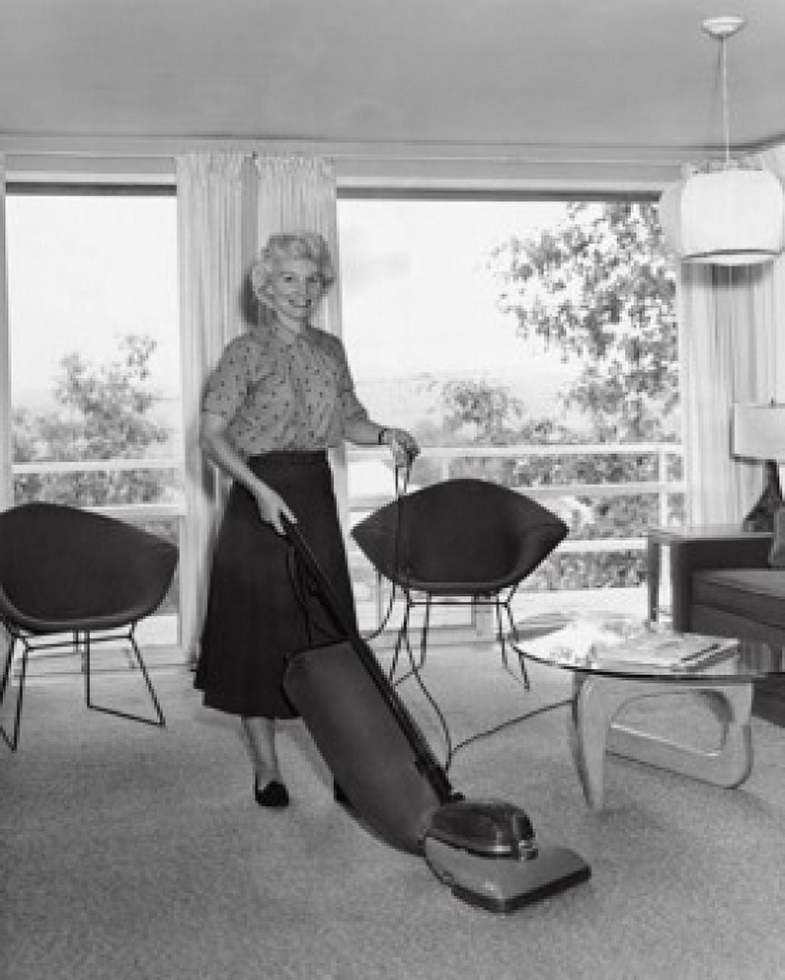 Mid adult woman vacuuming Canvas Art - (18 x 24)