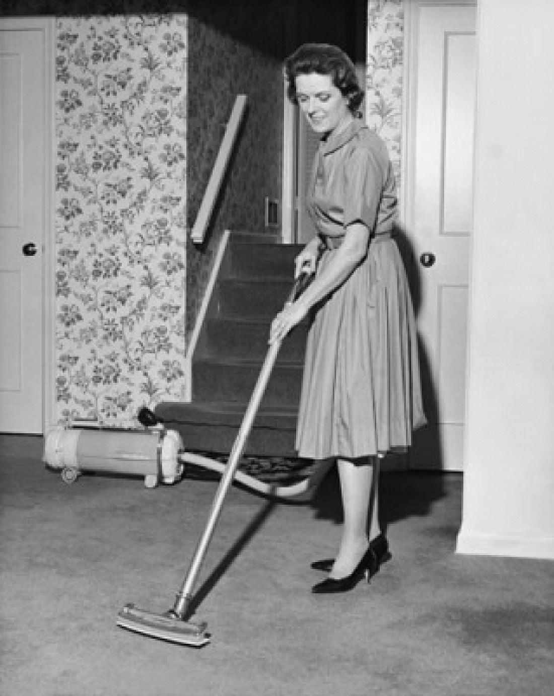 Mid adult woman vacuuming Canvas Art - (18 x 24)