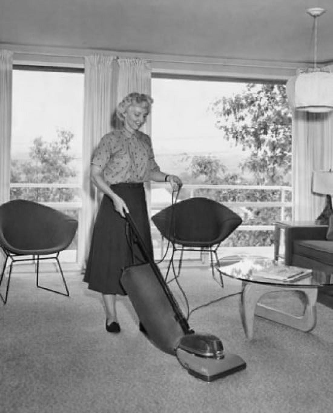 Mid adult woman vacuuming Canvas Art - (24 x 36)