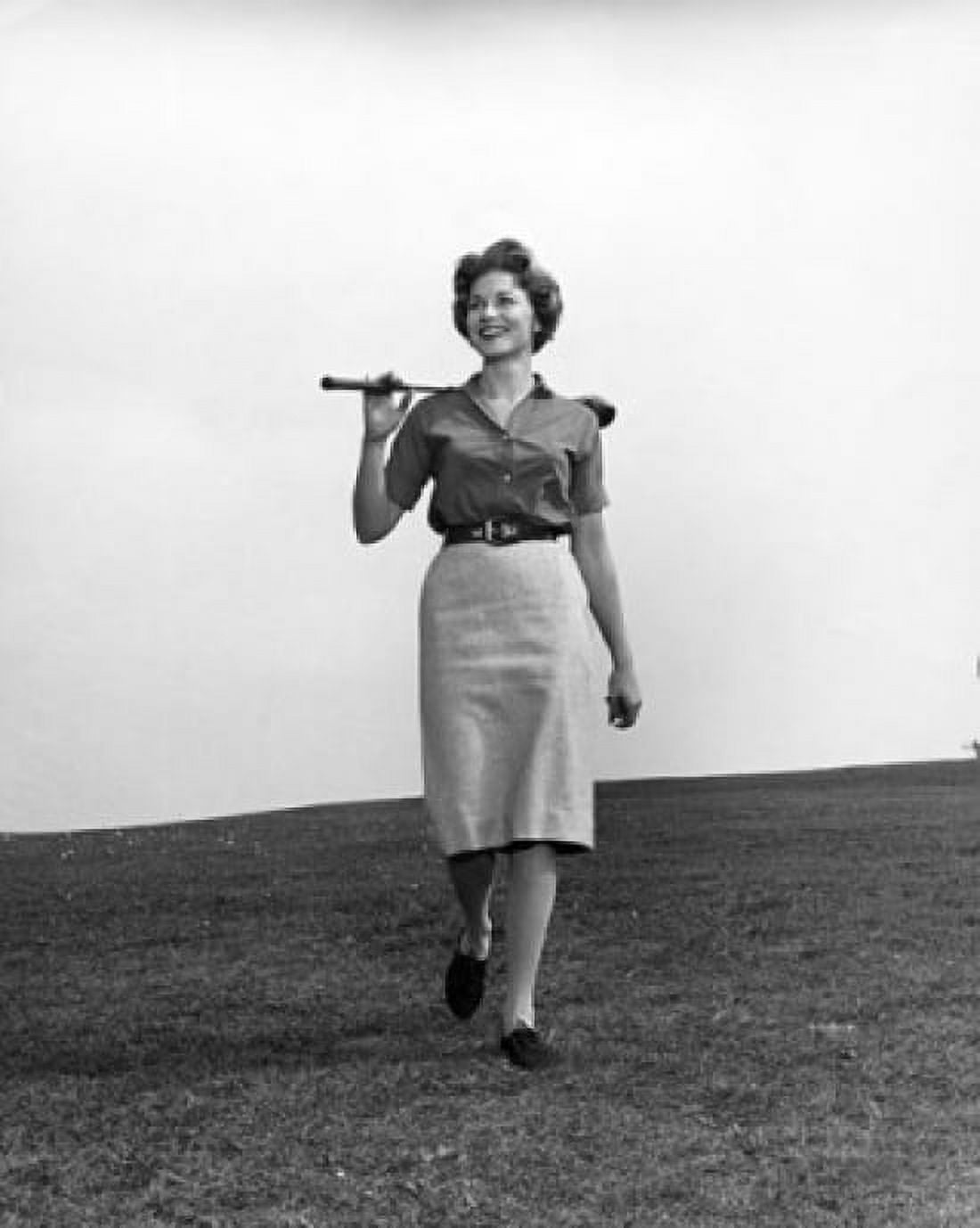 Mid adult woman walking on a golf course with a golf club Canvas Art - (18 x 24)