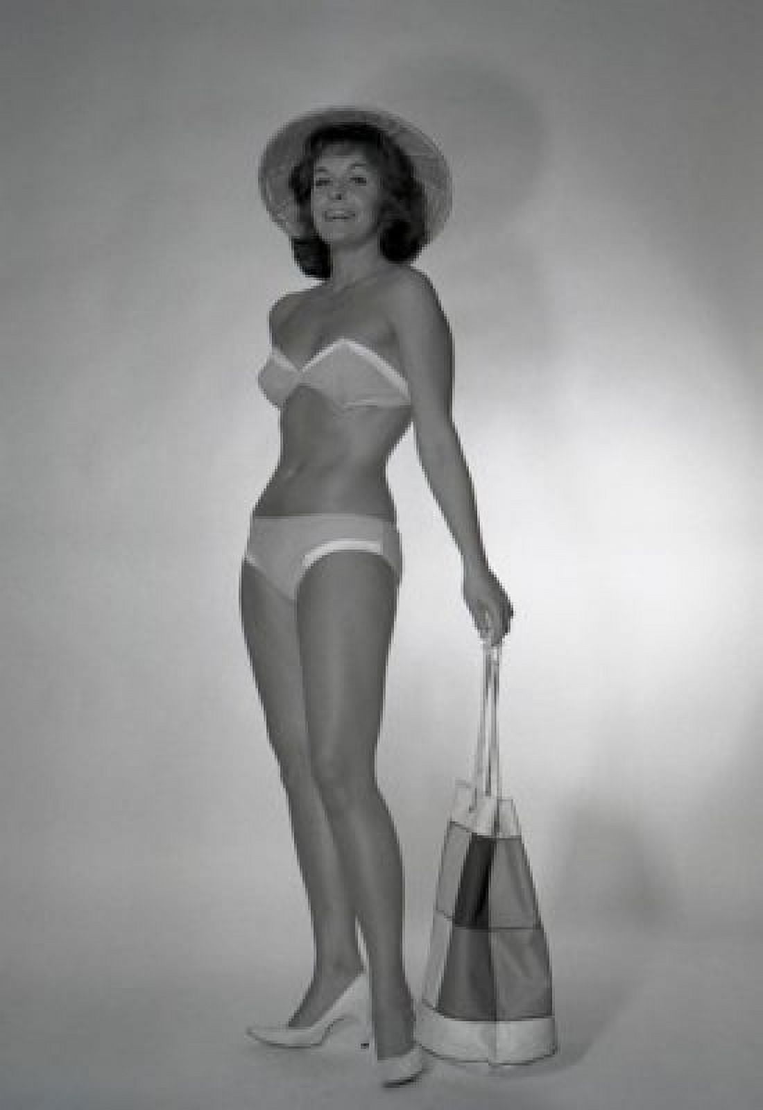 Mid adult woman wearing bikini and straw hat holding beach bag Canvas Art - (18 x 24)
