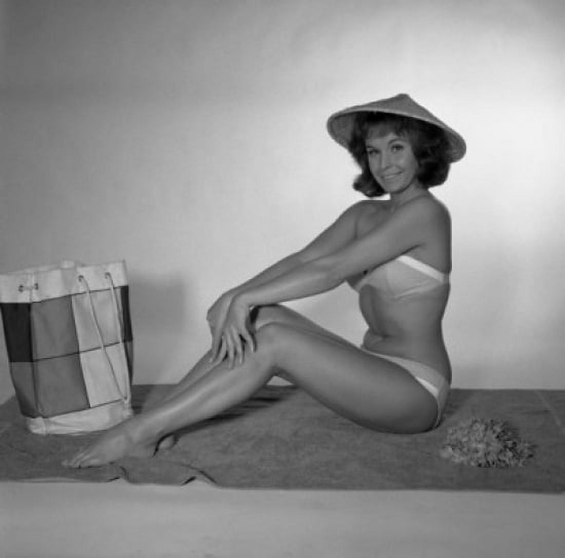 Mid adult woman wearing bikini sitting on towel Canvas Art - (24 x 36)